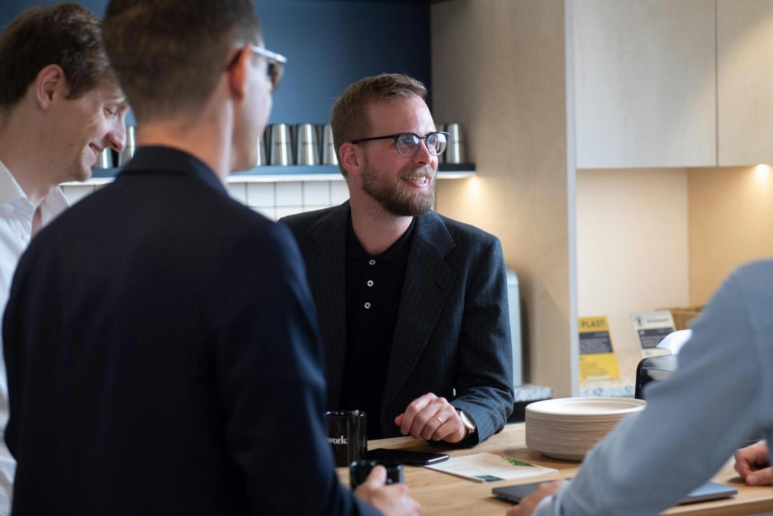 Business professionals analyzing financial data and reports in modern office setting
